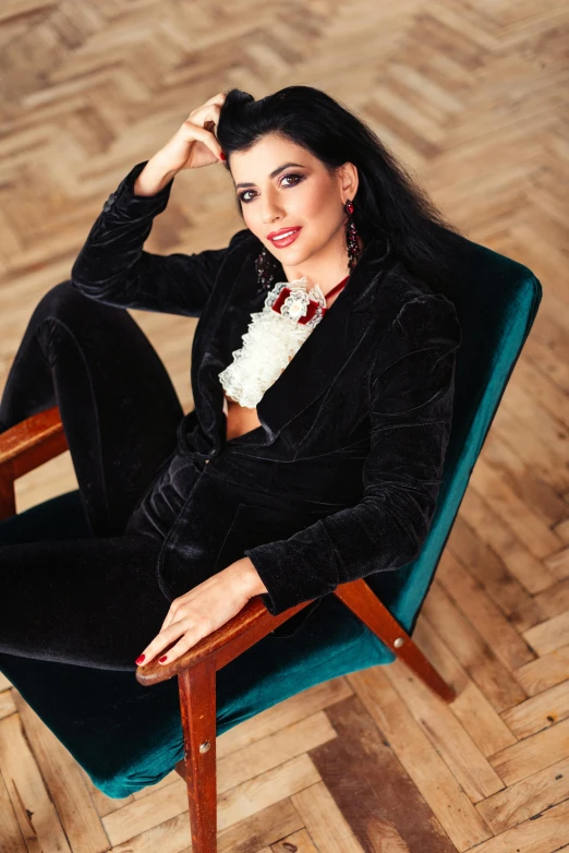 a woman posing for a po wearing black on the chair