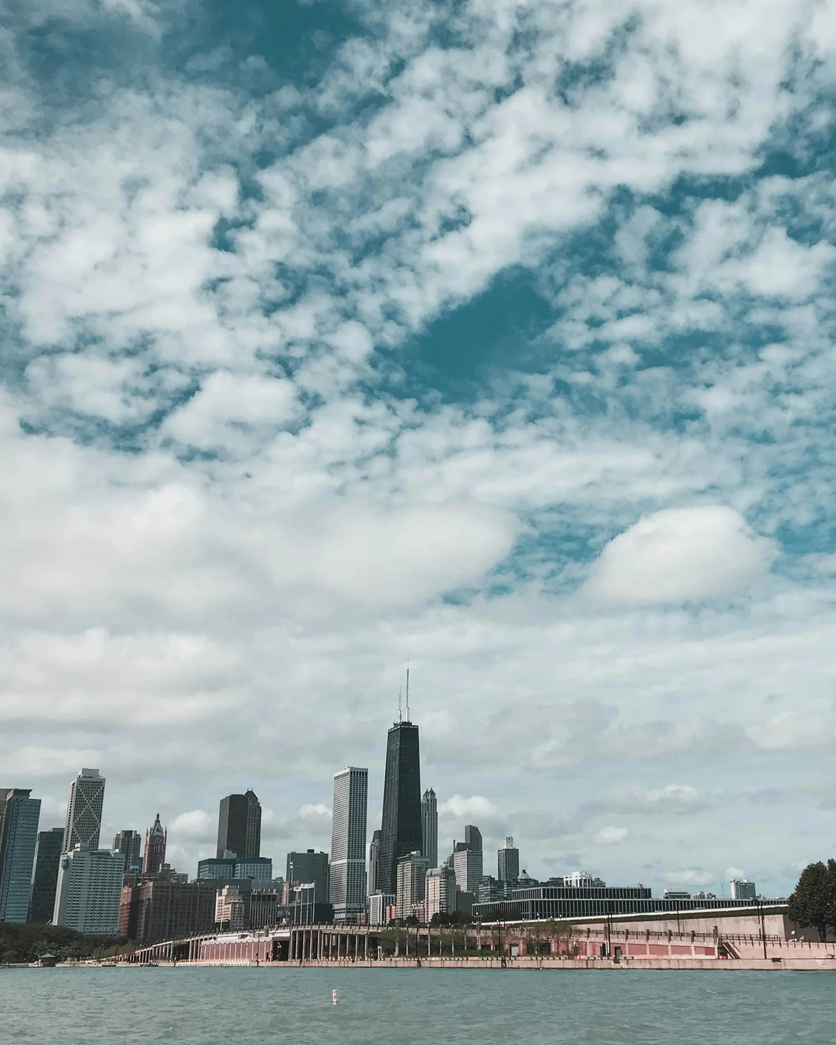 a group of buildings near the water on a cloudy day