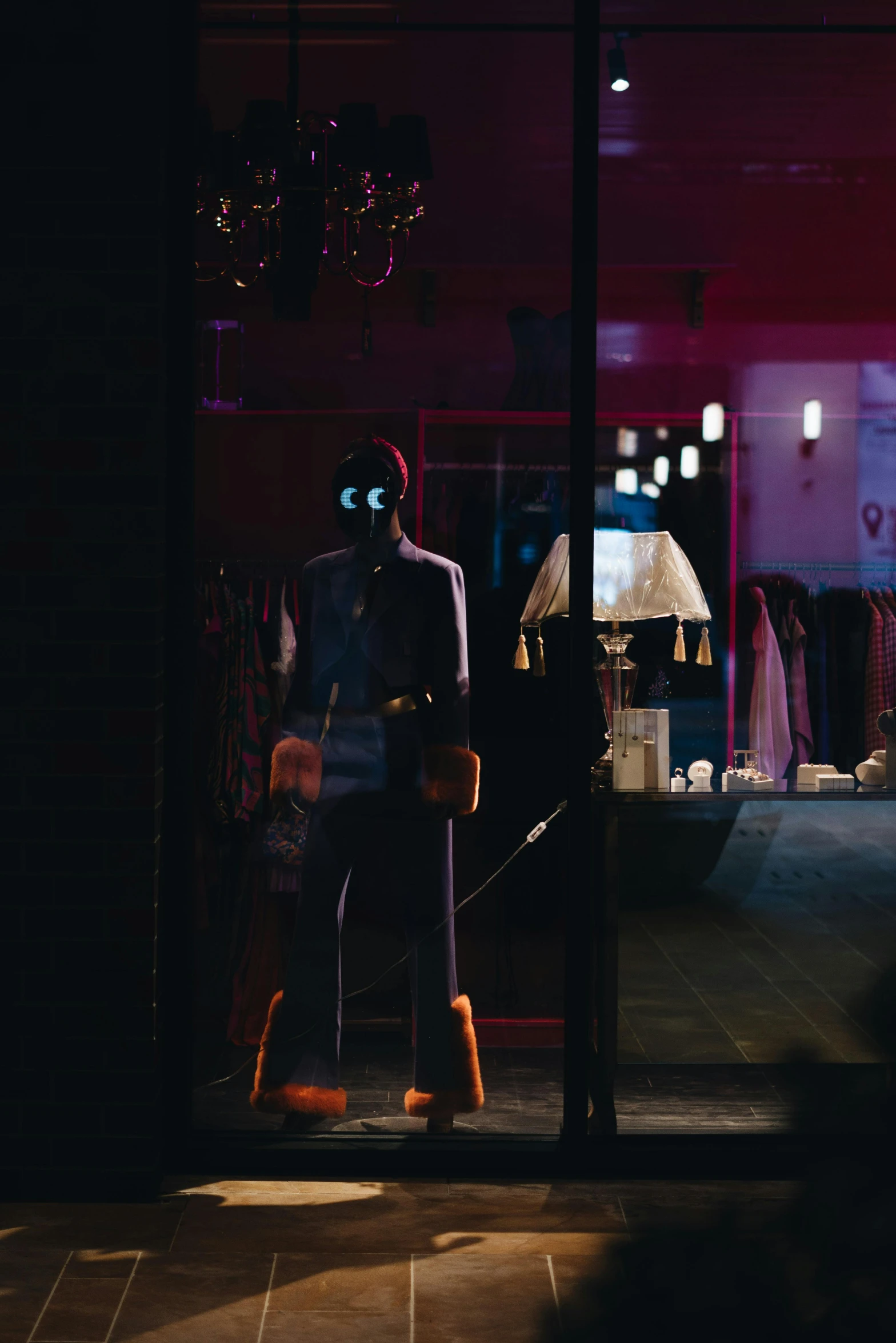 a window display with a mannequin dressed in a top hat and boots