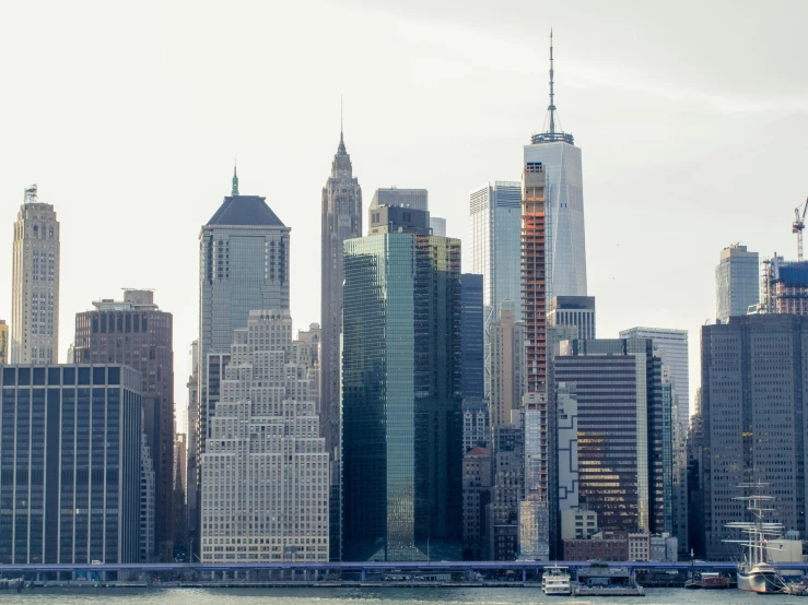 several boats on the water in front of some tall buildings