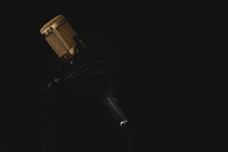 an old fashioned microphone sits upright in the dark