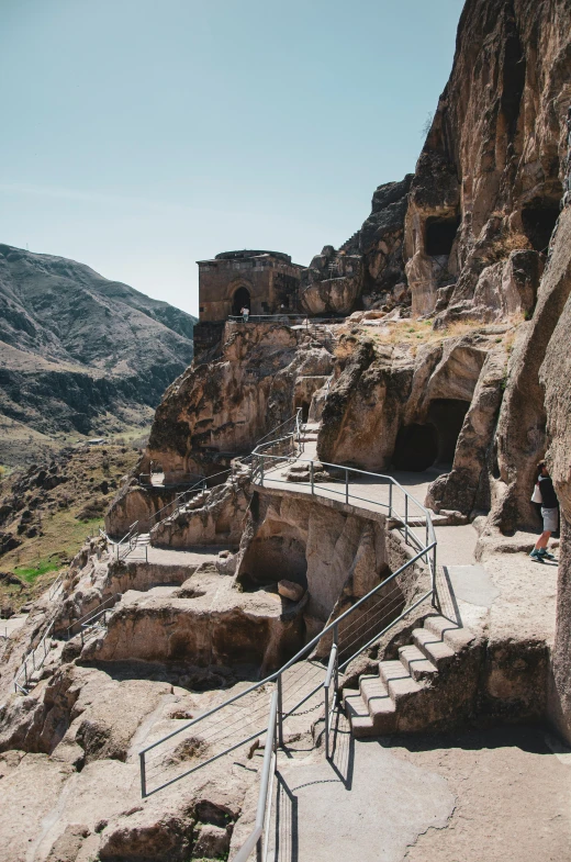 a rocky mountain side with stairs between some cliff walls