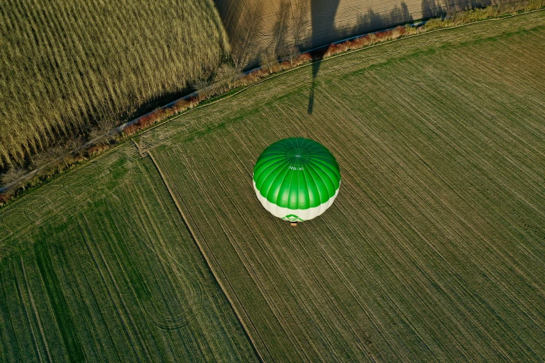 an overhead po of a balloon in the middle of a field