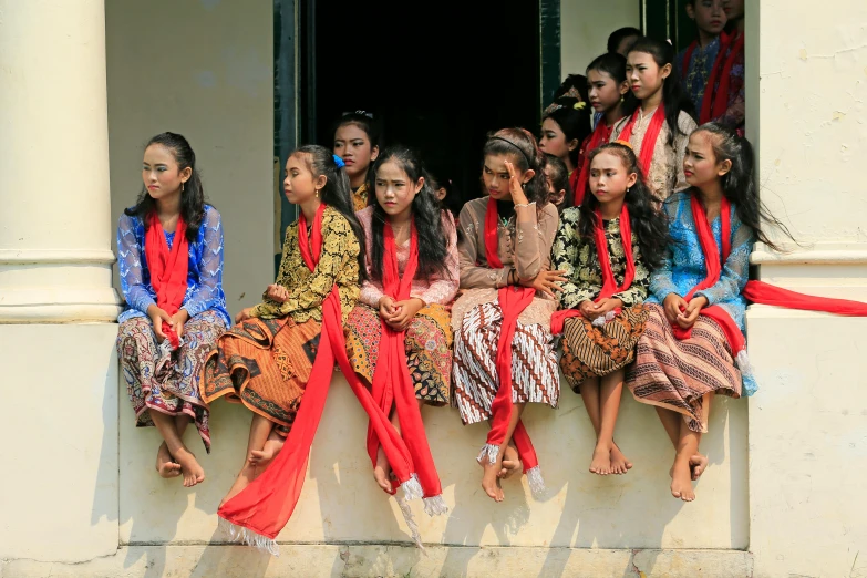 a group of s sitting on a window sill