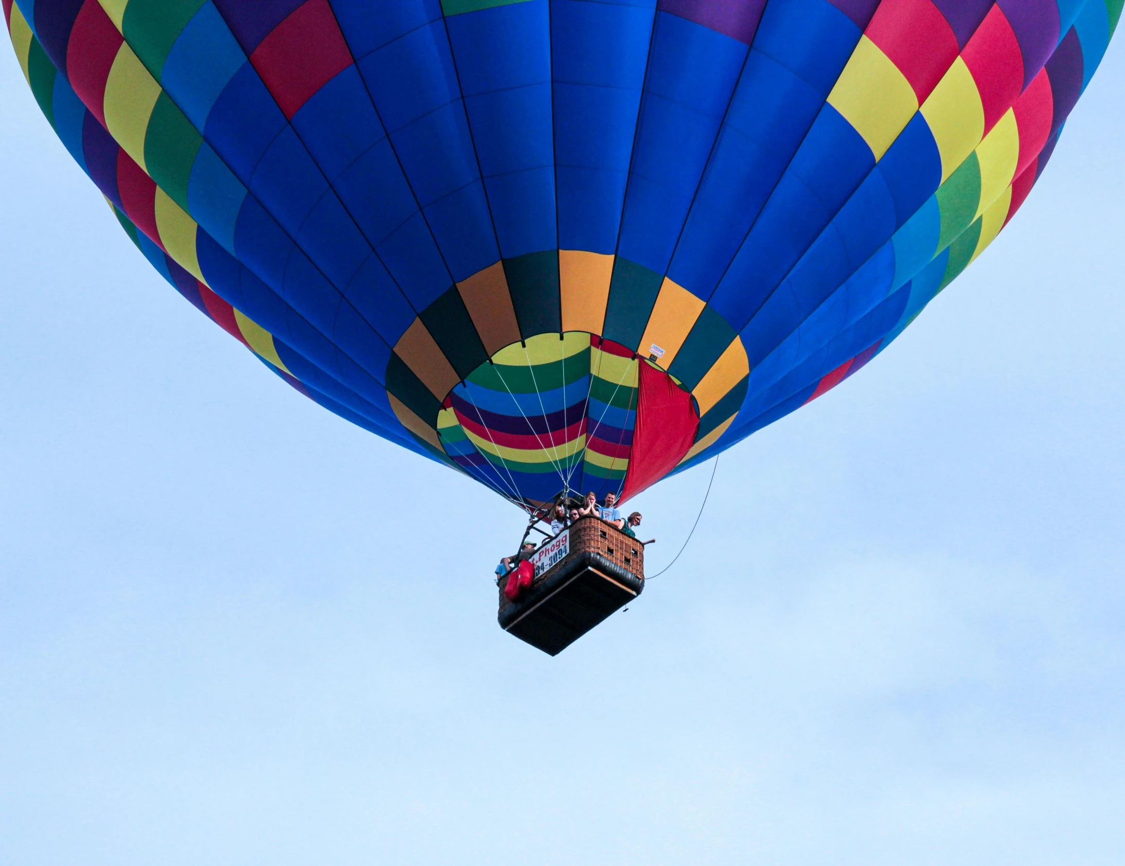 a large colorful balloon is flying through the sky