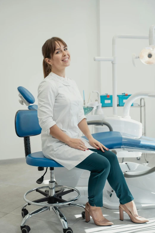 a woman sitting on a chair in a dentists office