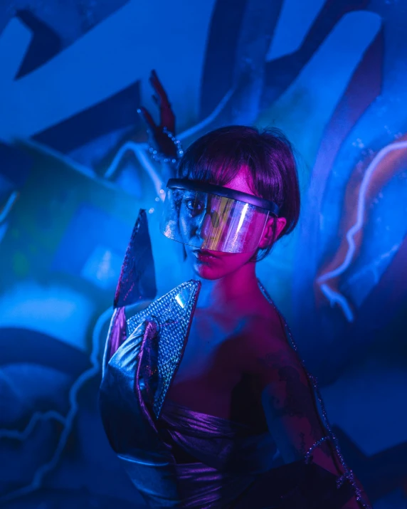 a woman in futuristic clothing poses with sci - fi goggles and makeup