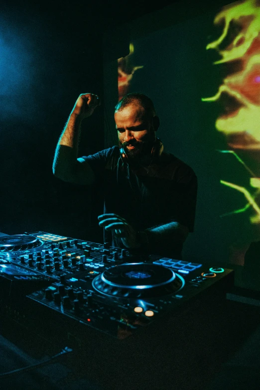 a man that is mixing some music on a turn board