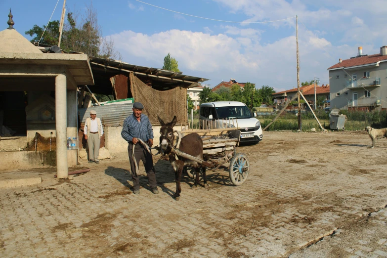 a man standing next to a horse in the street