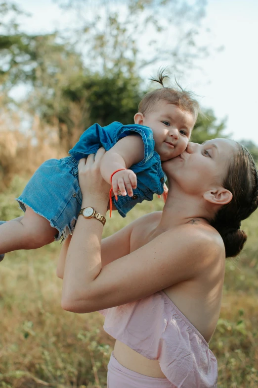 a woman is holding a baby in her arms