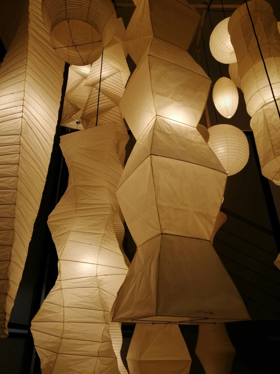 several paper lanterns are displayed in a room