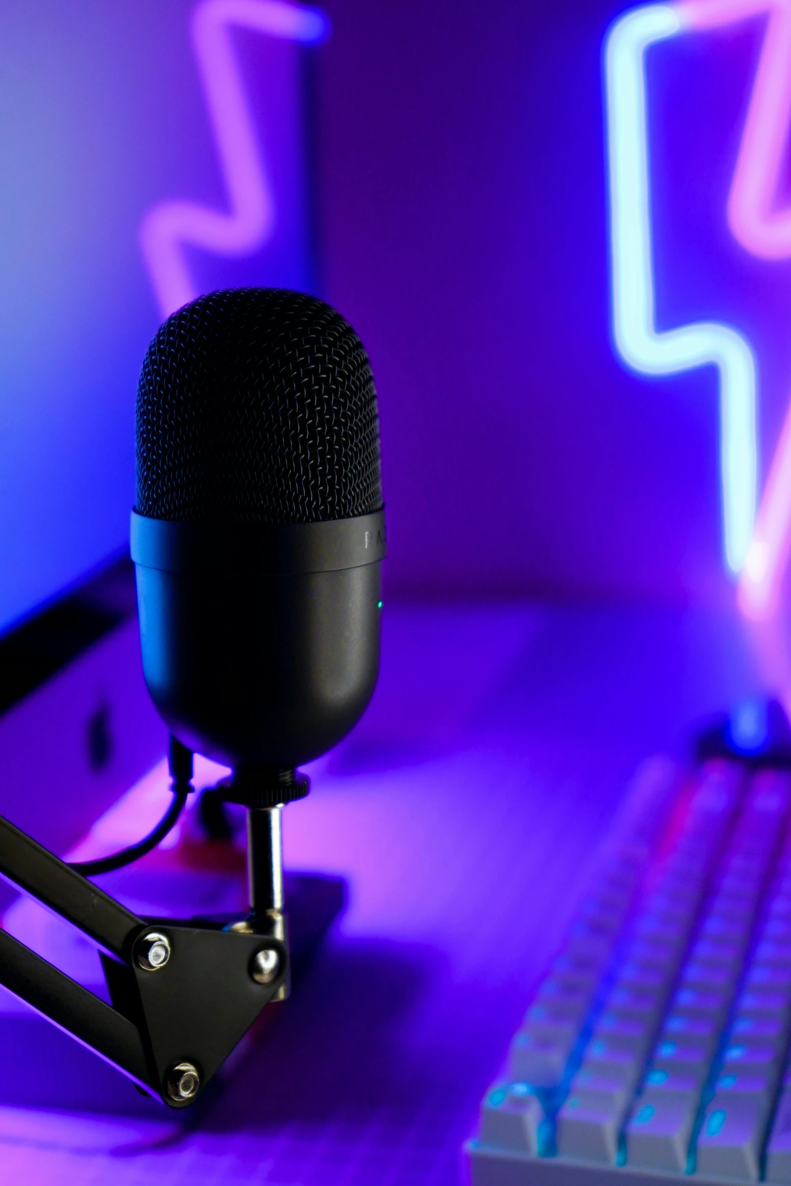 a microphone sits next to a laptop in front of it