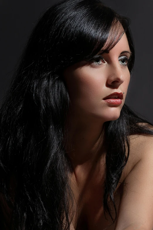 woman with long dark hair and smoky makeup