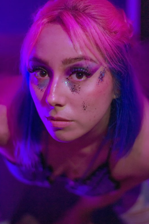 a girl with her eyes closed and face painted purple