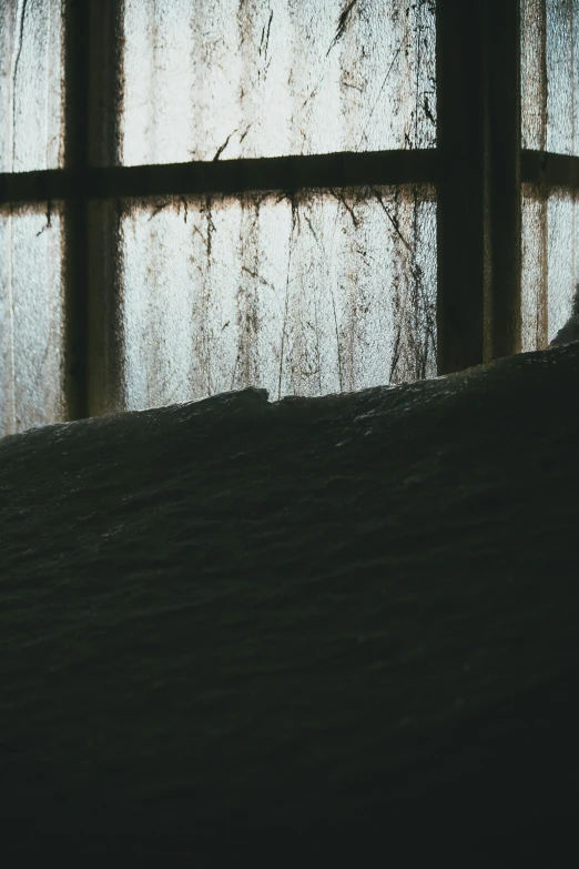 a window that is partially closed in front of a wall