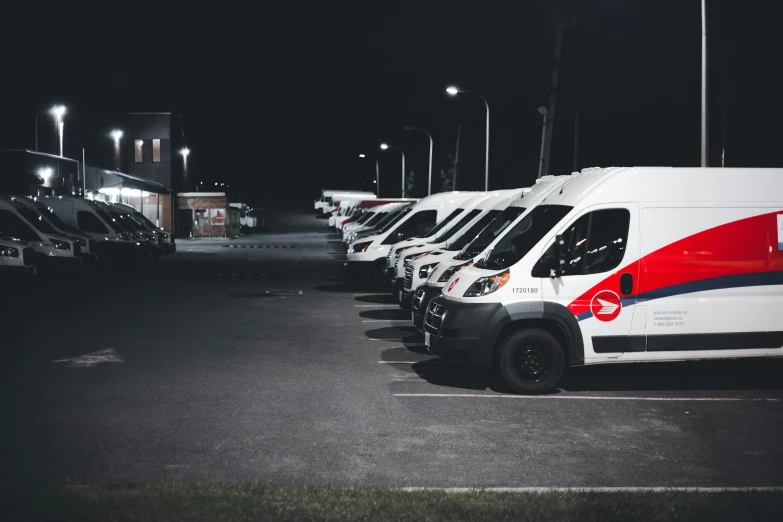 a parking lot with rows of van parked on both sides of it