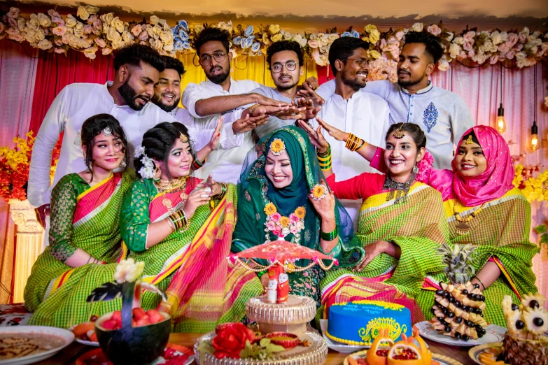 a group of indian people in traditional clothing poses for a po