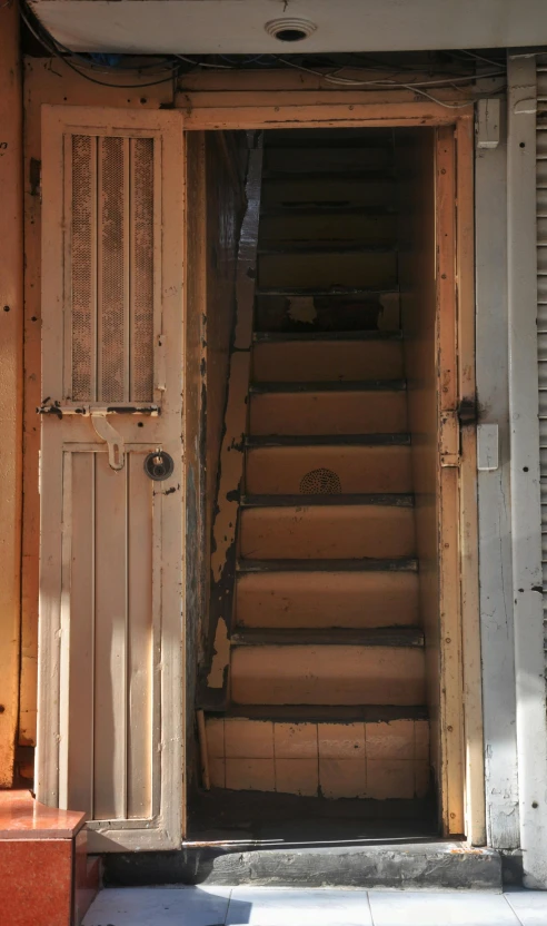an open door leading to stairs in an old building