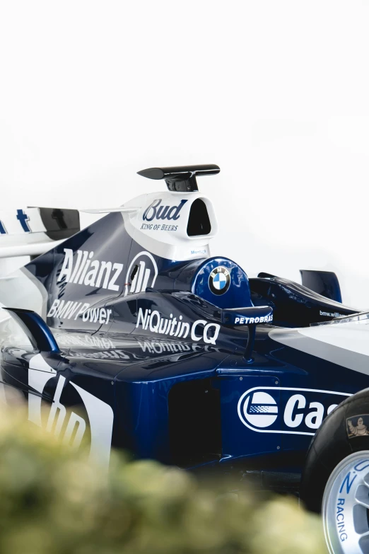 a closeup of a blue and white car on the track