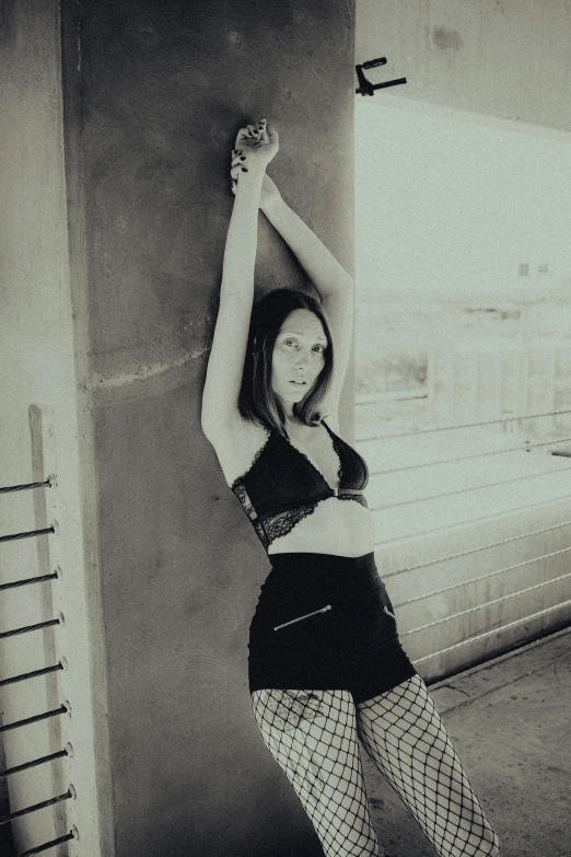 a young woman is posing with her hand in the air