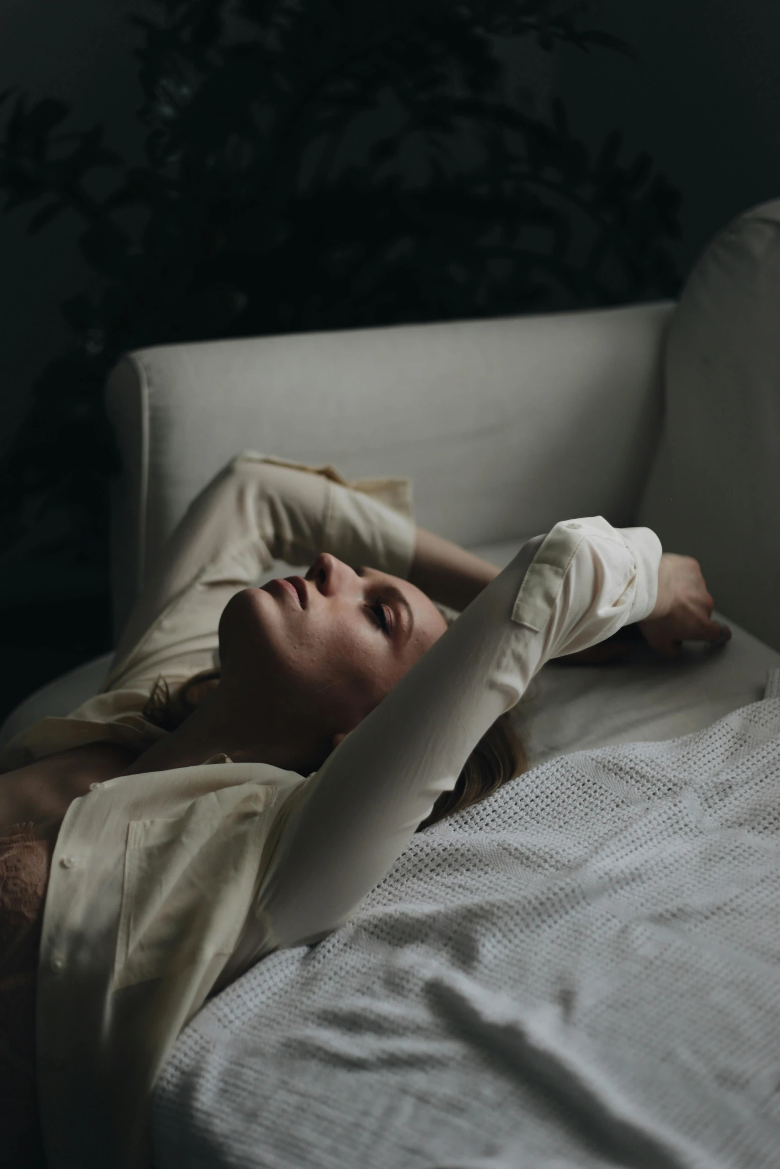 a woman laying on her side with both arms crossed