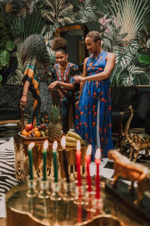 a woman with her family blowing out candles on cake