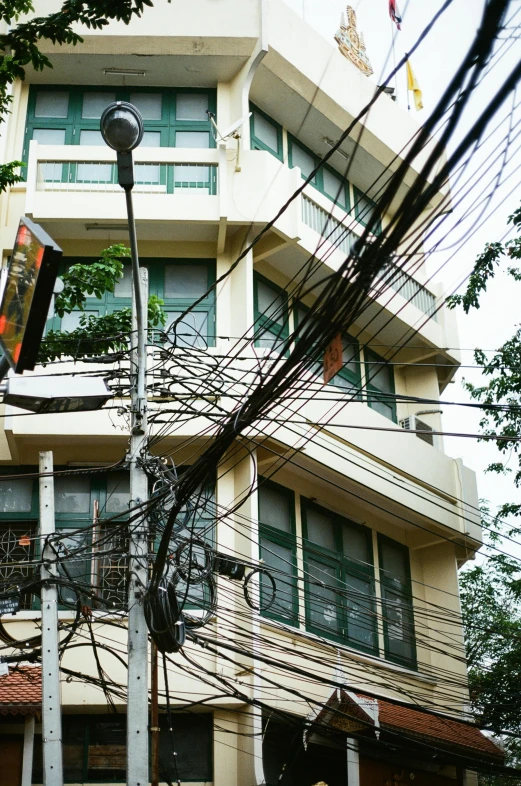 a large building that is behind telephone wires