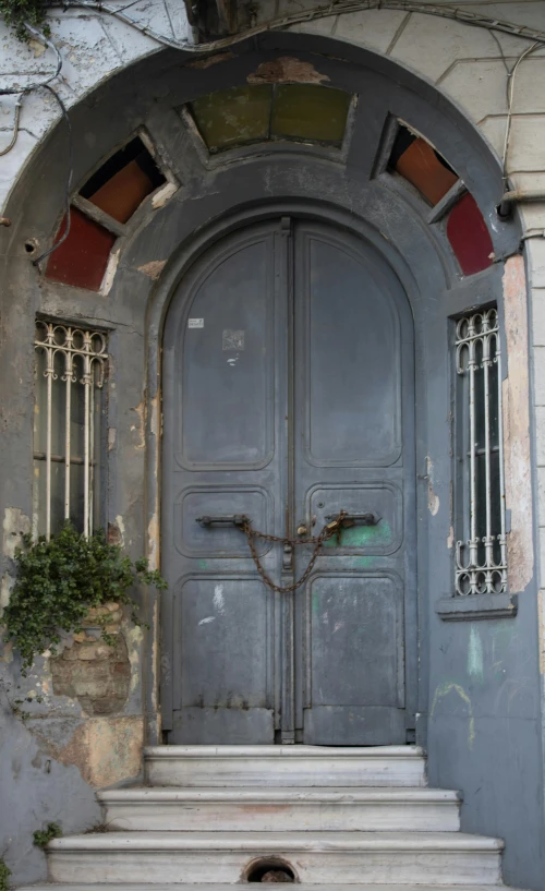 an old door with two large arched windows