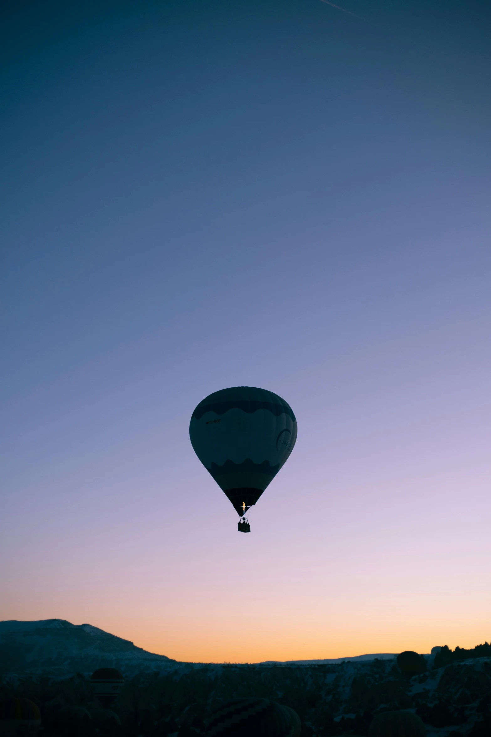 a  air balloon flying over some buildings