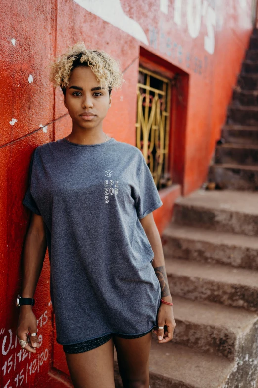 a woman standing by some stairs posing for a picture