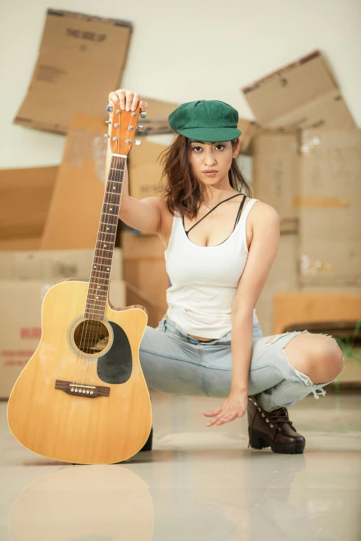 a beautiful young woman holding an acoustic guitar