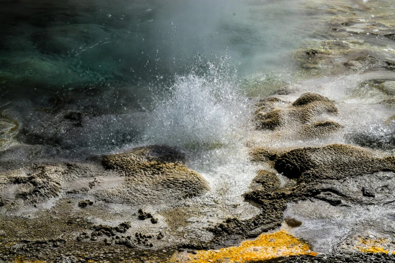 a water fountain and steaming  steams on a dirty street