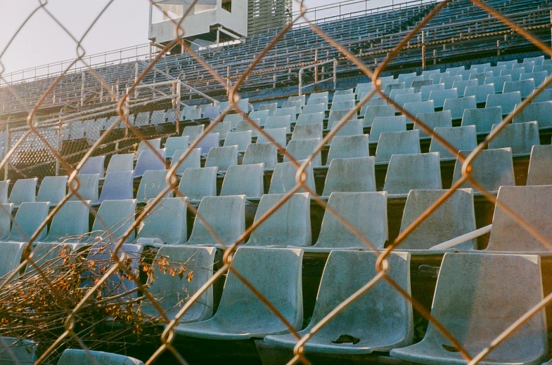 a row of plastic chairs in a stadium