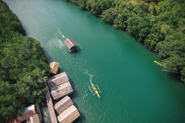 a kayaker floats on the water in front of houses