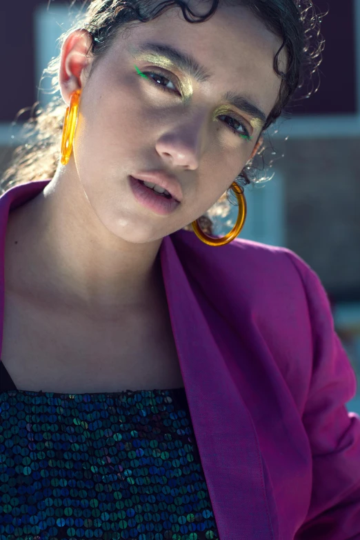 a woman in a bright purple coat has colorful makeup