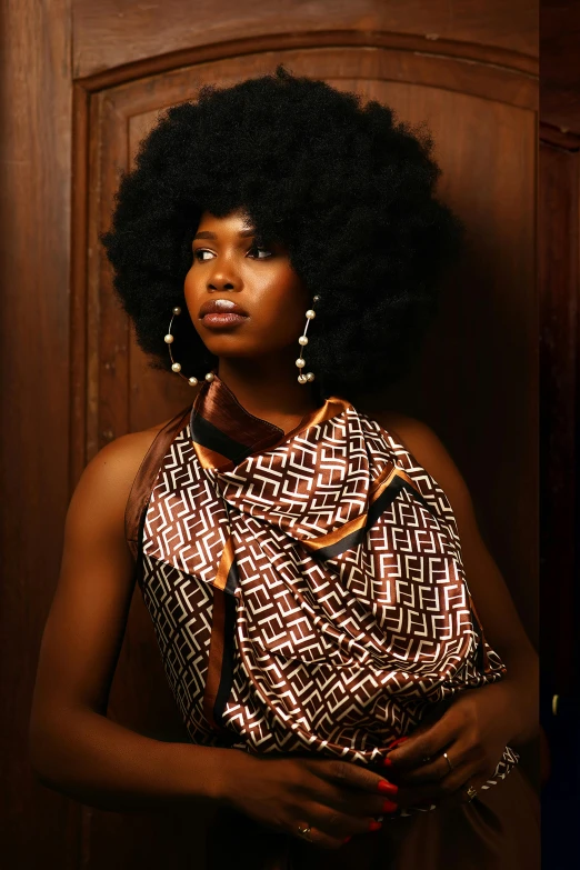 an african american woman with afro in front of a wooden door