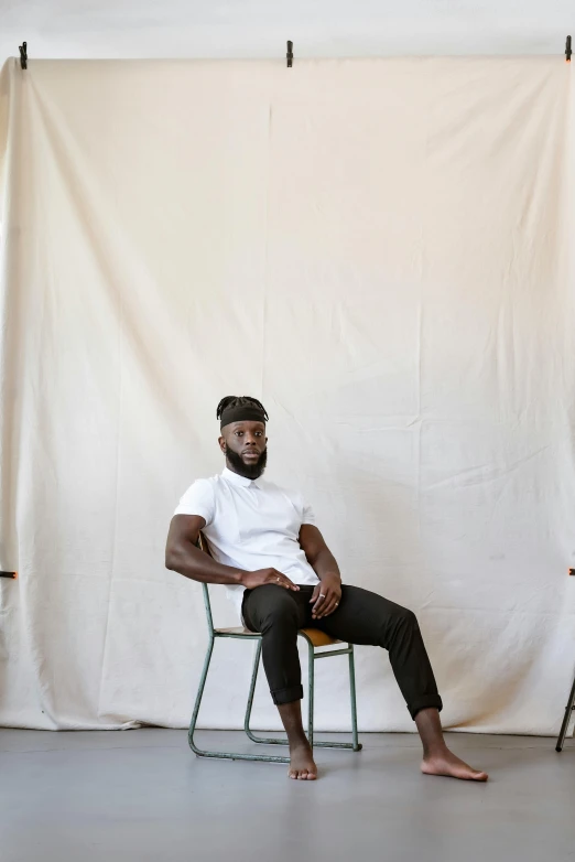 man with a headset sitting on a chair