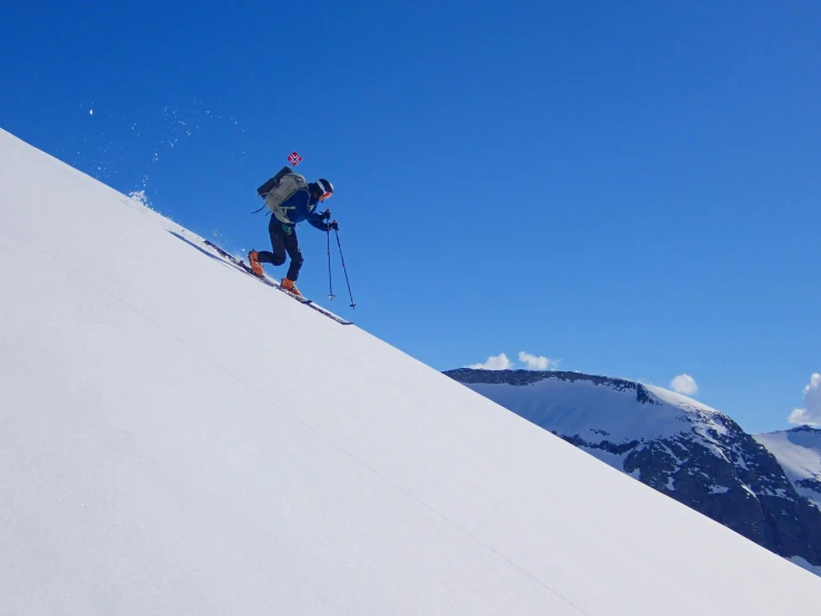 two skiers are coming down the snow - covered mountain slope