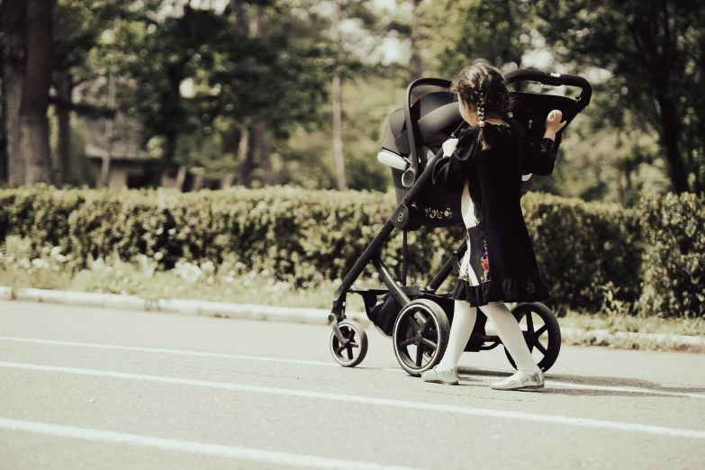 the woman is hing a stroller behind her