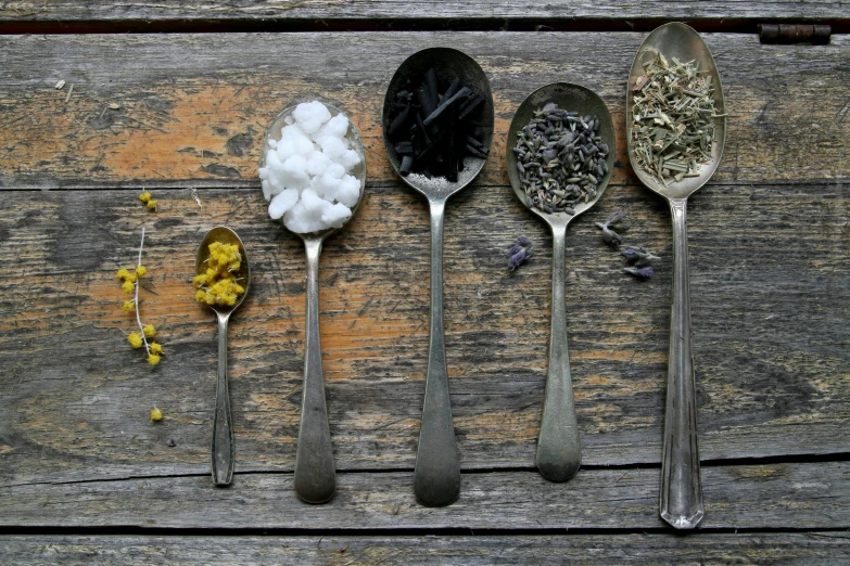 five spoons with a mixture of different kinds of food