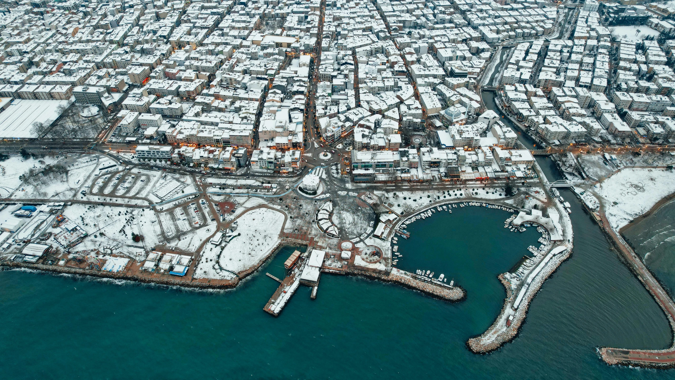 an aerial view of a harbor in winter