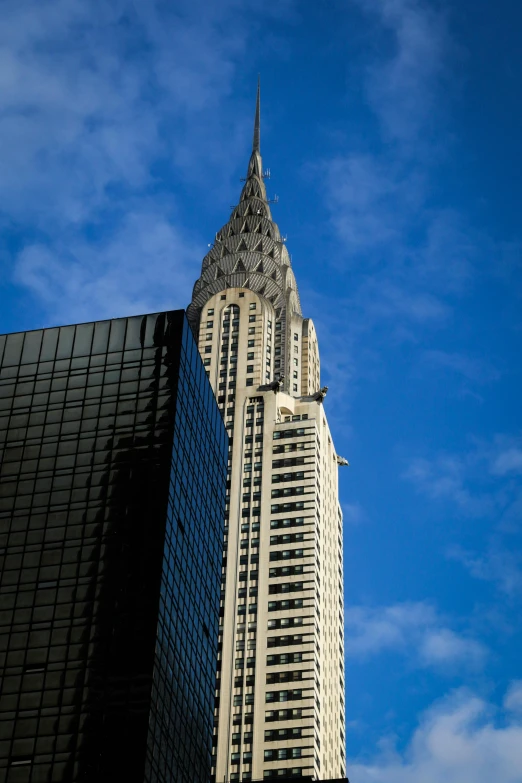 there is a building with a spire in front of blue skies