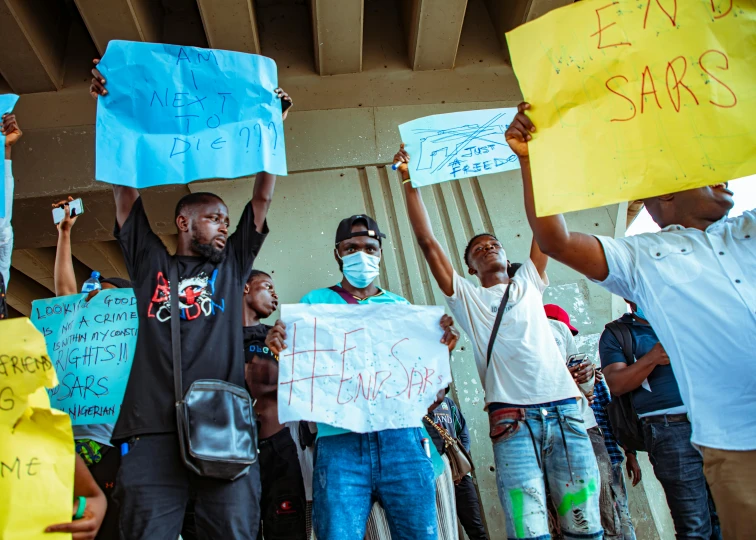 a group of people holding up protest signs