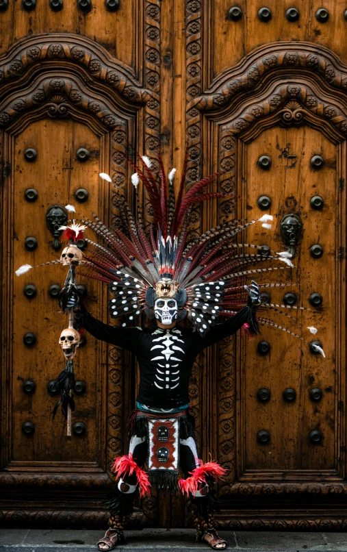 a wooden door with a statue of a skeleton in front