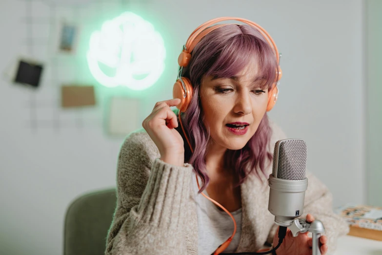 a woman wearing headphones while holding a microphone