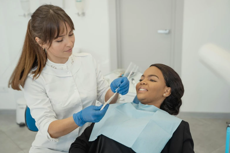 a woman getting a haircut from her hair stylist