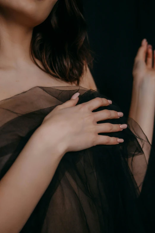 a woman's hand holding on to her shirt