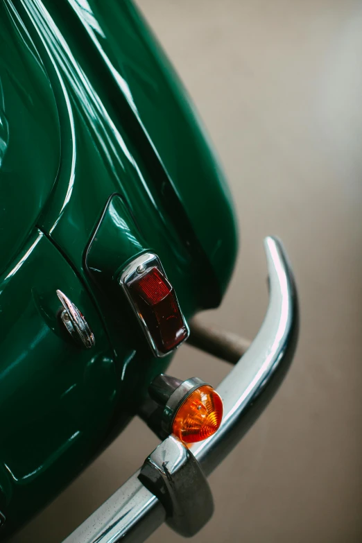 the tail light of a green motorcycle is on