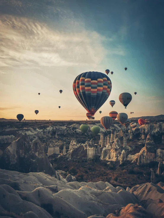 a landscape image of  air balloons flying in the sky