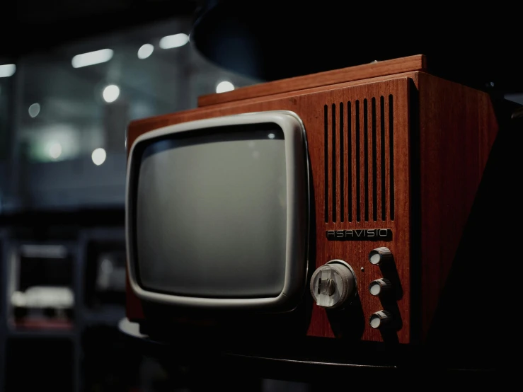 the old fashioned television is displayed in the dark